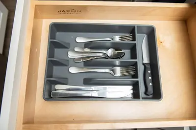 a drawer filled with utensils in a box at The Hideaway at Lake Ridge 3 in Fort Lauderdale