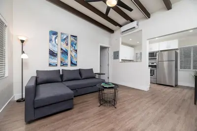 a living room with a couch and a kitchen at The Hideaway at Lake Ridge 1 in Fort Lauderdale