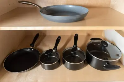 a shelf with four pots and a bowl on it at The Hideaway at Lake Ridge 1 in Fort Lauderdale