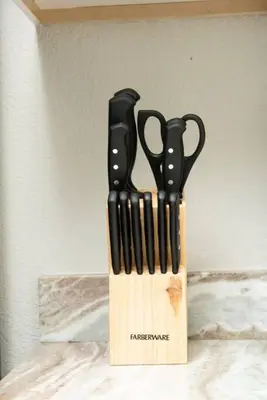 a knife block with black handled scissors in it at The Hideaway at Lake Ridge 2 in Fort Lauderdale