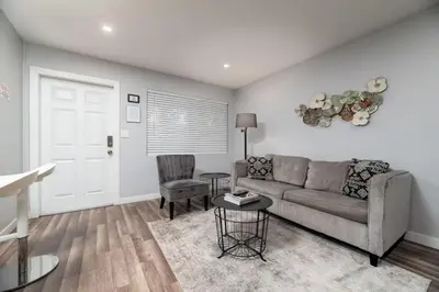a living room with a couch and a table at The Palms at Middle River Terrace 3 in Fort Lauderdale