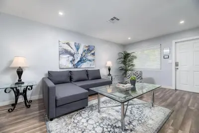 a living room with a couch and a table at The Palms at Middle River Terrace 2 in Fort Lauderdale