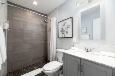 a white bathroom with a toilet and a sink at The Palms at Middle River Terrace 2 in Fort Lauderdale
