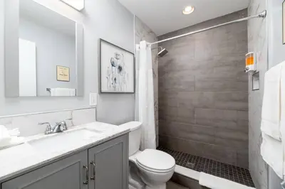a white bathroom with a toilet and a sink at The Palms at Middle River Terrace 1 in Fort Lauderdale