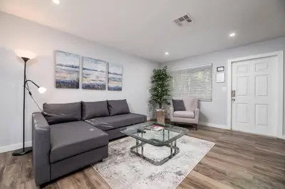 a living room with a couch and a glass table at The Palms at Middle River Terrace 4 in Fort Lauderdale