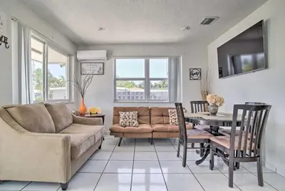 a living room with a couch and a table at Fort Lauderdale Duplex about 5 Mi to Downtown! in Fort Lauderdale