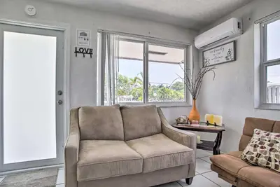 a living room with a couch and a chair at Fort Lauderdale Duplex about 5 Mi to Downtown! in Fort Lauderdale