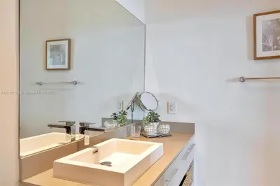a bathroom with a sink and a mirror at Penthouse Condo at Lyfe Resort and Residences in Hollywood