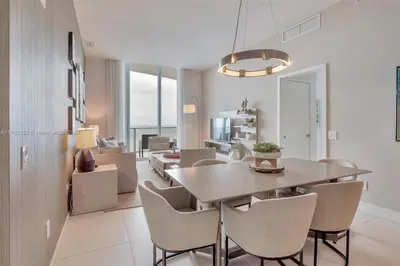 a dining room and living room with a table and chairs at Penthouse Condo at Lyfe Resort and Residences in Hollywood