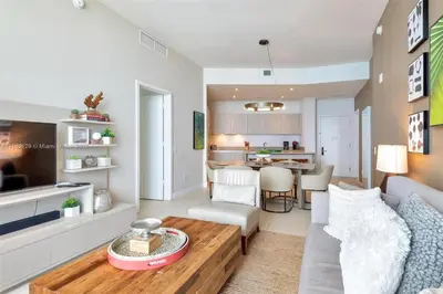 a living room with a couch and a table at Penthouse Condo at Lyfe Resort and Residences in Hollywood