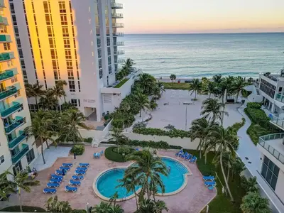 an aerial view of a resort with a pool and the ocean at Great apartment in Hollywood with side ocean view! Direct access to the beach! 14th floor in Hollywood