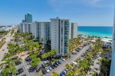 an aerial view of a beach with palm trees and buildings at Great apartment in Hollywood with side ocean view! Direct access to the beach! 14th floor in Hollywood