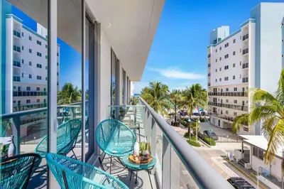 a balcony with chairs and a table and a street at Amazing Pool - Balcony - Up To 6 - Near Beach in Hollywood