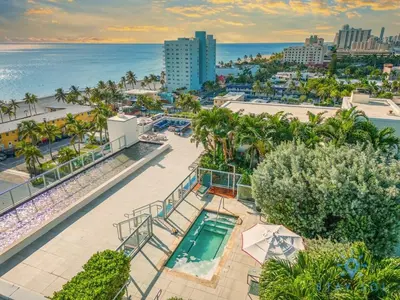 an aerial view of a resort with a pool and the ocean at Amazing Pool - Gym - Hot Tub - Near Beach in Hollywood