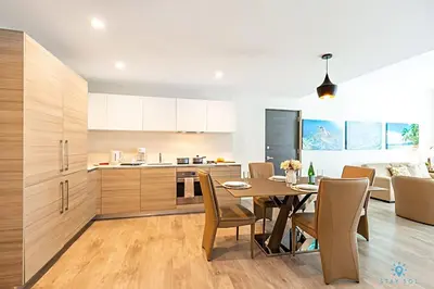 a kitchen and dining room with a table and chairs at Rooftop Pool, Broad-walk & Near Beach in Hollywood