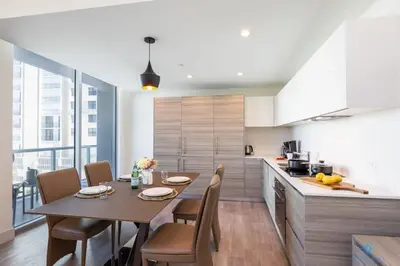 a kitchen with a table and chairs in a room at 5 Tropical Oasis ROOFTOP infinity POOL Hot Tub on Hollywood Boardwalk in Hollywood