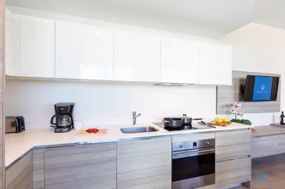 a kitchen with white cabinets and a sink at 5 Tropical Oasis ROOFTOP infinity POOL Hot Tub on Hollywood Boardwalk in Hollywood