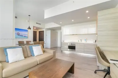 a large living room with a couch and a kitchen at Rooftop Pool - Hot Tub - Gym - Near Beach in Hollywood