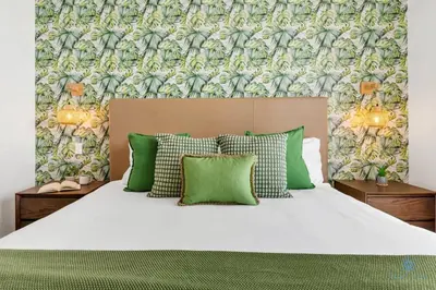 a bedroom with a large bed with green pillows at Hollywood Beach - Front Bay View - Amazing Pool in Hollywood