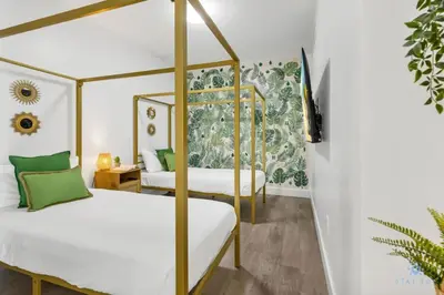 two beds in a room with green and white at Hollywood Beach - Front Bay View - Amazing Pool in Hollywood
