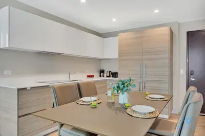 a kitchen with a table and chairs in a kitchen at Rooftop Pool - Balcony - Hollywood Beach - Gym in Hollywood