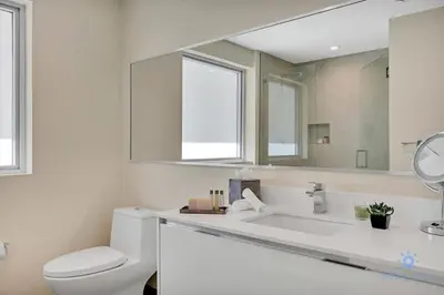 a bathroom with a toilet and a large mirror at Rooftop Pool - Balcony - Hollywood Beach - Gym in Hollywood