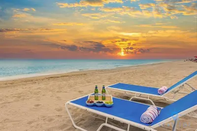 a picnic table on the beach with bottles of beer at Hot tub & Rooftop pool - Near Beach in Hollywood