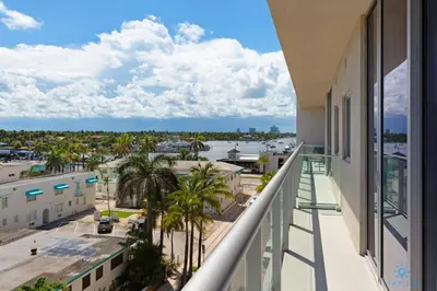 a balcony with palm trees and a view of the water at Balcony - Hollywood Beach Broad-walk - Rooftop Pool in Hollywood
