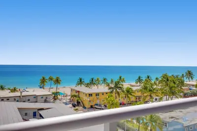 a view of the beach from a balcony at Ocean View Balcony - Rooftop Pool & Hot Tub - Gym in Hollywood
