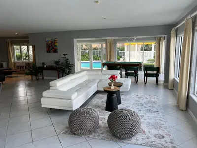 a living room with a white couch and a table at WaterFront 4BR 3B,Intercoastal,Pool,5 min walk to beach-7 in Fort Lauderdale