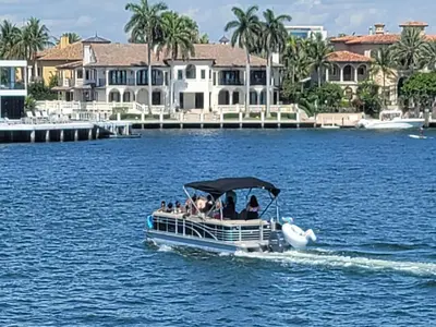 a group of people on a boat in the water at WaterFront 4BR 3B,Intercoastal,Pool,5 min walk to beach-7 in Fort Lauderdale