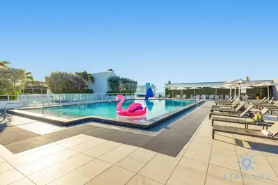 a swimming pool with a pink flamingo in the middle at Best Stay - Rooftop Pool & Hot Tub - Hollywood Beach in Hollywood
