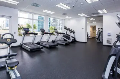 a gym with treadmills and elliptical machines at Gorgeous 2BR in the Heart of Brickell, Free Parking in Miami