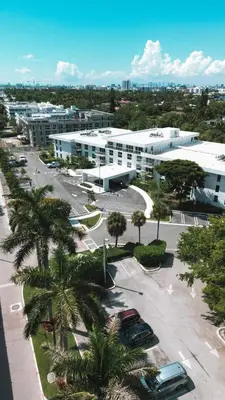 arial view of a building with cars parked in a parking lot at Beach Haus Residences in Bal Harbour