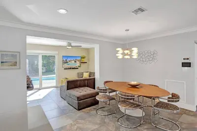 a living room with a table and a couch at Hollywood Villa close to the BEACH w/HEATED POOL in Hollywood