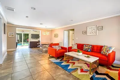 a living room with red couches and a table at Hollywood Villa close to the BEACH w/HEATED POOL in Hollywood