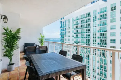 a balcony with a table and chairs and a building at Amazing 2 BR APT at Brickell, Free Parking in Miami