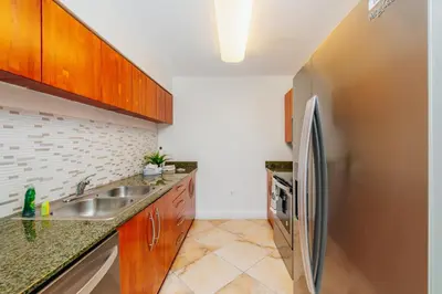 a kitchen with a sink and a refrigerator at Amazing 2 BR APT at Brickell, Free Parking in Miami