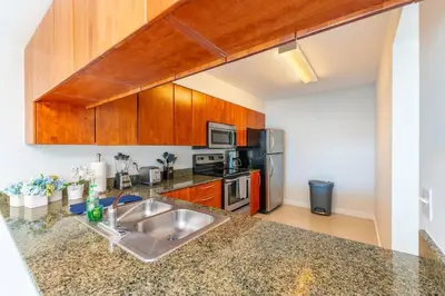 a kitchen with a sink and a stove top oven at Stunning 2BR with Ocean View at Brickell, Free Parking in Miami