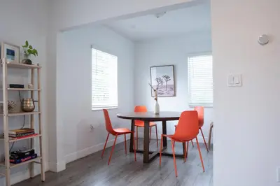 a dining room with a table and orange chairs at Casa MIA central location, free parking, fully equipped in Miami