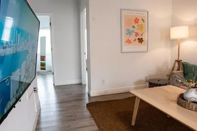 a living room with a table and a tv at Casa MIA central location, free parking, fully equipped in Miami