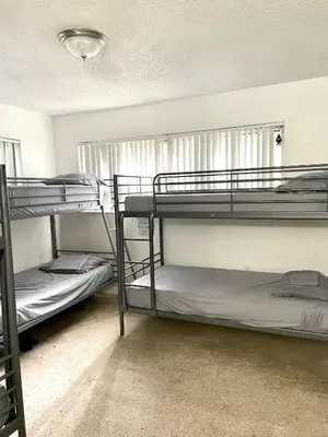 a room with three bunk beds in it at Miami House in Miami