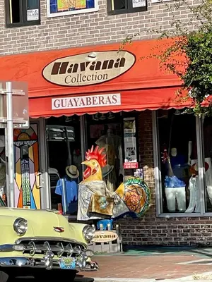 an old car parked in front of a store at Miami House in Miami