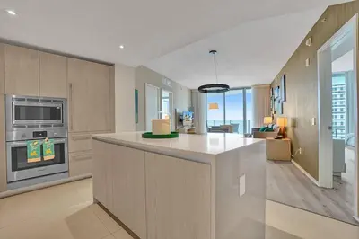 a kitchen with a counter and a living room at Amazing apartments at Lyfe Resort & Residences in Hollywood
