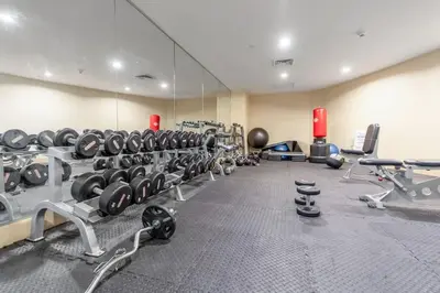 a gym with a row of dumbbells and a mirror at Biscayne Bay View Stay Pool Hot Tub and Amenities in Miami