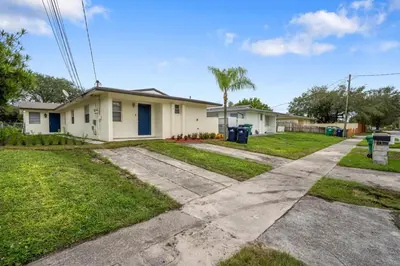 a house with a driveway in front of it at Blue Door Duplex Renovated Parking and Designed in Cutler Bay