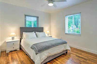 a bedroom with a large bed and two windows at Central Miami Home about 10 Mi to Local Beaches! in Miami