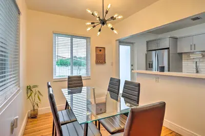 a dining room with a glass table and chairs at Central Miami Home about 10 Mi to Local Beaches! in Miami
