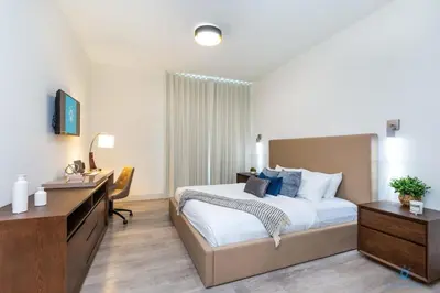 a hotel room with a bed and a desk and a desk at Hollywood Beach Broad-walk - Pool - Gym & Hot Tub in Hollywood