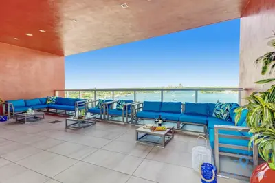 a large room with blue couches and tables at Hollywood Beach Broad-walk - Pool - Gym & Hot Tub in Hollywood